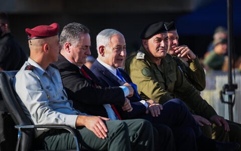 Defense Minister Israel Katz,  second left, Prime Minister Benjamin Netanyahu, second right, and IDF Chief of Staff Lt. Gen. Eyal Zamir attend the graduation ceremony of an IDF officers’ course in southern Israel, June 25, 2026. (Flash90)