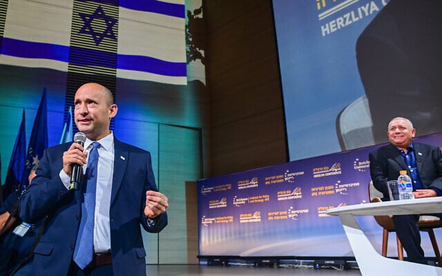 Former prime minister Naftali Bennett speaks as former IDF chief Gadi Eisenkot looks on during a conference at the Reichman University in Herzliya, July 1, 2026. (Avshalom Sassoni/Flash90) Former prime minister Naftali Bennett speaks as former IDF chief Gadi Eisenkot looks on during a conference at the Reichman University in Herzliya, July 1, 2026. (Avshalom Sassoni/Flash90)
