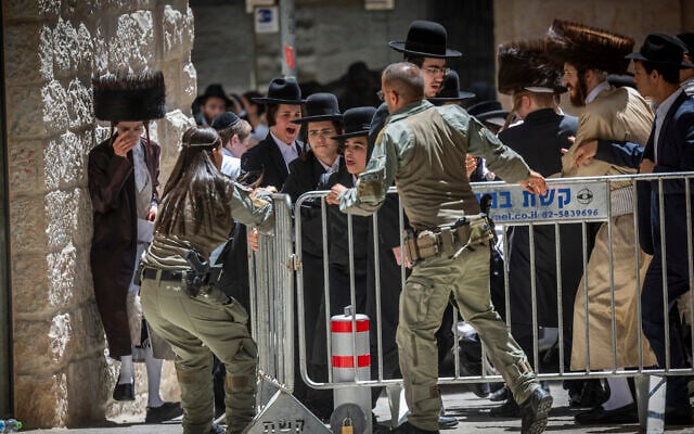 Ultra-Orthodox protesters clash with police during a protest against a cafe operating on Shabbat in central Jerusalem, July 25, 2026. (Yonatan Sindel/Flash90)