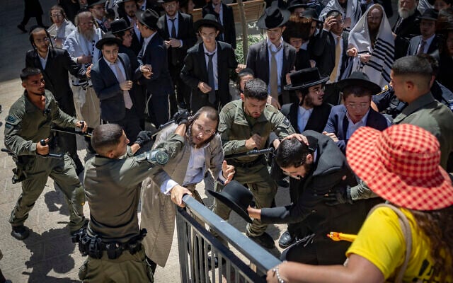 Ultra-Orthodox protesters demonstrate against a cafe operating on Shabbat and clash with Israeli police in Jerusalem, August 1, 2026. (Yonatan Sindel/Flash90)