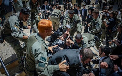 Ultra-Orthodox protesters demonstrate against a cafe operating on Shabbat and clash with Israeli police, while secular protesters hold a counter-demonstration in support of the cafe in central Jerusalem, August 1, 2026. (Yonatan Sindel/Flash90)