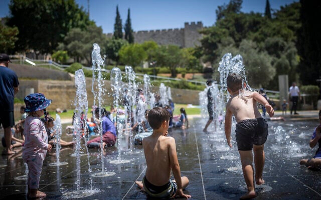 Children play in a water fountain on a hot summer day near the Tower of David, outside Jerusalem’s Old City, on August 2, 2026. (Yonatan Sindel/Flash90)