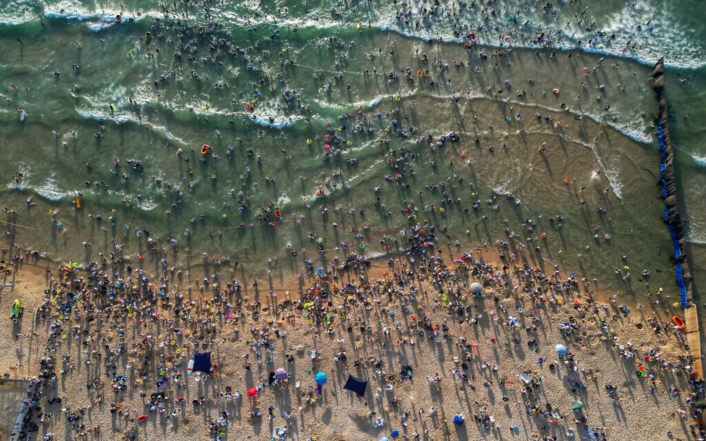 Ultra-Orthodox men bathe at a gender-segregated beach in Ashdod, August 3, 2026. (Chaim Goldberg/Flash90)
