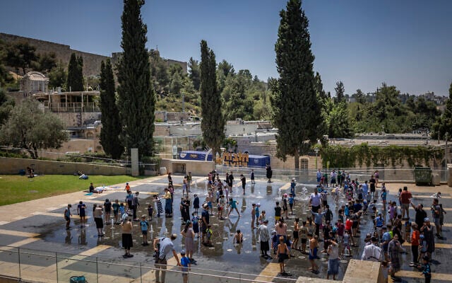 Children play in a water fountain on a hot summer day near the Tower of David, outside Jerusalem’s Old City, on August 3, 2026. (Yonatan Sindel/Flash90)