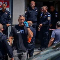 Police work outside the law firm where a lawyer was shot dead on August 4, 2026. (Avshalom Sassoni/FLASH90)