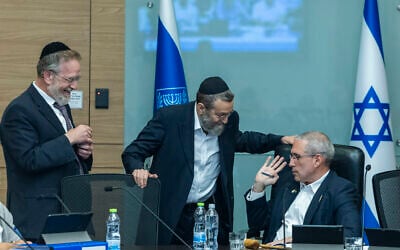 Finance Committee chair MK Hanoch Milwidsky, right, speaks with MKs Moshe Gafni, center, and Yitzhak Pindrus during a Knesset Finance Committee meeting in Jerusalem, August 4, 2026, at which additional funding was approved for Haredi education. (Chaim Goldberg/Flash90) Finance Committee chair MK Hanoch Milwidsky, right, speaks with MKs Moshe Gafni, center, and Yitzhak Pindrus during a Knesset Finance Committee meeting in Jerusalem, August 4, 2026, at which additional funding was approved for Haredi education. (Chaim Goldberg/Flash90)