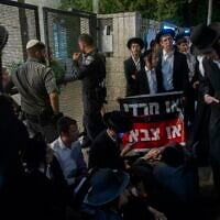 Ultra-Orthodox protesters demonstrate against an IDF recruitment conference for the Haredi community in Jerusalem, August 4, 2026. (Chaim Goldberg/Flash90)