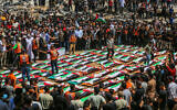 Palestinians perform burial rites at the mass funeral of people allegedly killed in a November 2023 Israeli strike, in Gaza City, August 4, 2026. (Fathi Ibrahim/Flash90)