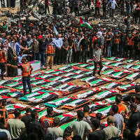 Palestinians perform burial rites at the mass funeral of people allegedly killed in a November 2023 Israeli strike, in Gaza City, August 4, 2026. (Fathi Ibrahim/Flash90)