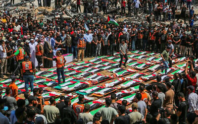 Palestinians perform burial rites at the mass funeral of people allegedly killed in a November 2023 Israeli strike, in Gaza City, August 4, 2026. (Fathi Ibrahim/Flash90) Palestinians perform burial rites at the mass funeral of people allegedly killed in a November 2023 Israeli strike, in Gaza City, August 4, 2026. (Fathi Ibrahim/Flash90)