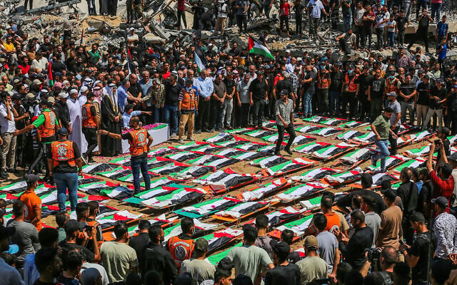 Palestinians perform burial rites at the mass funeral of people allegedly killed in a November 2023 Israeli strike, in Gaza City, August 4, 2026. (Fathi Ibrahim/Flash90)