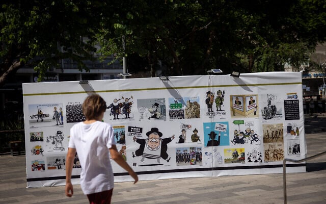 Illustrations on display outside the comics and caricature festival at the Cinemateque in Tel Aviv, August 4, 2026. (Miriam Alster/FLASH90)