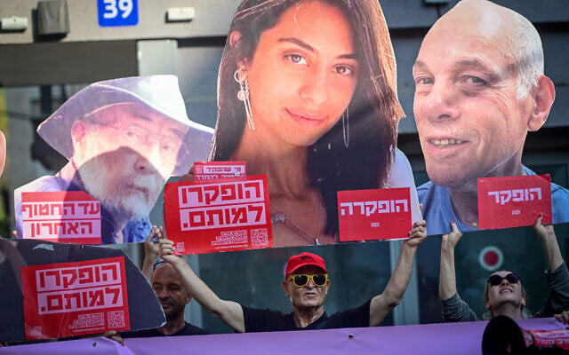 Israelis hold large images of Israeli hostages killed in Hamas captivity in Gaza, during a protest outside the Likud headquarters in Tel Aviv. August 9, 2026. (Avshalom Sassoni/FLASH90)