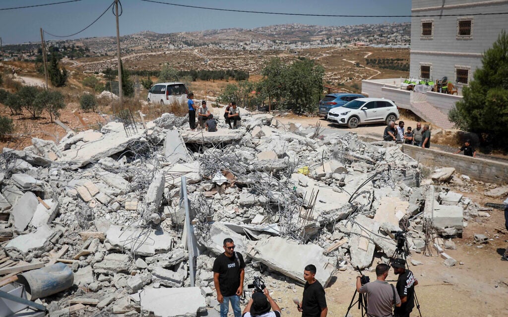 Palestinians inspect the rubble of a home after it was demolished by Israeli forces, near the West Bank city of Hebron, August 10, 2026. (Wisam Hashlamoun/FLASH90) Palestinians inspect the rubble of a home after it was demolished by Israeli forces, near the West Bank city of Hebron, August 10, 2026. (Wisam Hashlamoun/FLASH90)