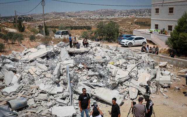 Palestinians inspect the rubble of a home after it was demolished by Israeli forces, near the West Bank city of Hebron, August 10, 2026. (Wisam Hashlamoun/FLASH90)