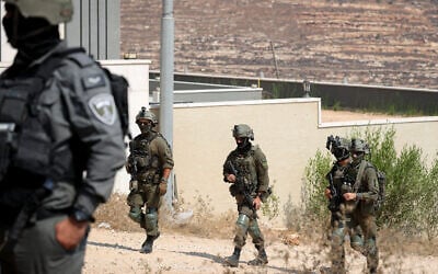 Troops seen outside homes that had been besieged by Israeli settlers in the village of Qusra in the West Bank, on August 14, 2026. (FLASH90) Troops seen outside homes that had been besieged by Israeli settlers in the village of Qusra in the West Bank, on August 14, 2026. (FLASH90)