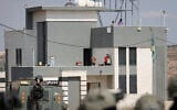 Israeli activists and Palestinian residents stand on the roof of a house besieged by Israeli settlers in the village of Qusra, south of Nablus, West Bank, on August 14, 2026. (FLASH90/ File)