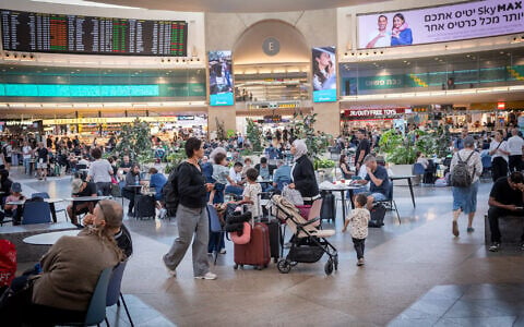 Travelers wait in the departures hall of Israel's Ben Gurion International Airport. August 11, 2026. (Nati Shohat/FLASH90)