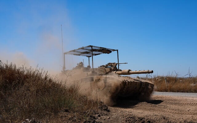 An IDF tank patrols along the border with Syria in the Golan Heights, August 20, 2026. (Ayal Margolin/Flash90)