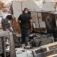 Palestinians inspect fire damage that residents said was caused by Israeli settlers in the Wadi al-Rakhim area of Yatta, south of Hebron in the West Bank, August 21, 2026. (Wisam Hashlamoun/Flash90)