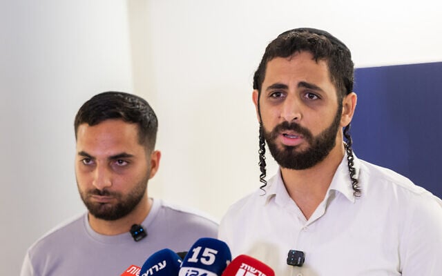 Shlomo and Yosef Hananya, brothers of stabbing victim Elhanan Hananya, speak to the media at Shaare Zedek Medical Center in Jerusalem, August 23, 2026. (Chaim Goldberg/Flash90) Shlomo and Yosef Hananya, brothers of stabbing victim Elhanan Hananya, speak to the media at Shaare Zedek Medical Center in Jerusalem, August 23, 2026. (Chaim Goldberg/Flash90)