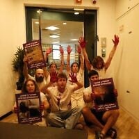 Protesters from the Arab-Jewish left-wing movement Standing Together block the entrance to the Religious Zionism party's office in Shoham, August 5, 2026. (Standing Together on X)