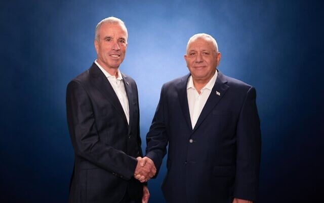 Former Yesh Atid MK Elazar Stern (left) shakes hands with Yashar party leader Gadi Eisenkot, in an image published on August 24, 2026. (Gadi Eisenkot/X)
