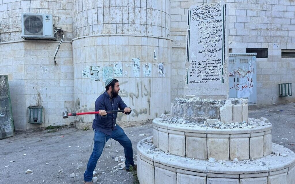 Far-right lawmaker Zvi Sukkot smashes a Palestinian monument to 'martyrs' in the West Bank village of Madama, August 25, 2026 (MK Zvi Sukkot's office)
