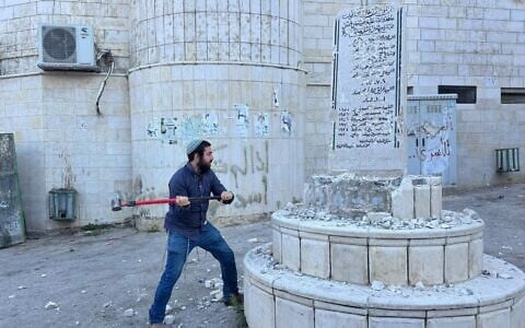 Far-right lawmaker Zvi Sukkot smashes a Palestinian monument to 'martyrs' in the West Bank village of Madama, August 25, 2026 (MK Zvi Sukkot's office)