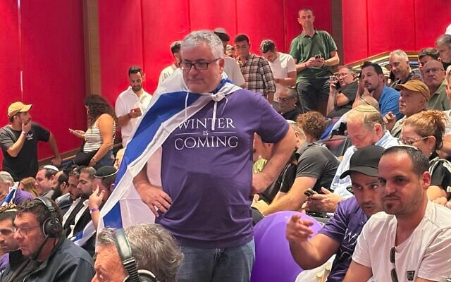A supporter attends the launch of former general Ofir Winter’s new political party in Jerusalem, August 25, 2026. (Sam Sokol/Times of Israel)