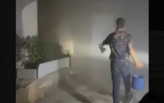 Residents in Khirbet a-Tuba in the West Bank's South Hebron Hills attempt to douse flames after extremist settlers allegedly set fire to several homes and attacked people, August 6, 2026 (video screenshot; used in accordance with Clause 27a of the Copyright Law)