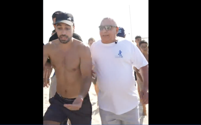 Far-right provocateur Mordechai David (left) confronts politician Gadi Eisenkot on August 7, 2026. (Screenshot)