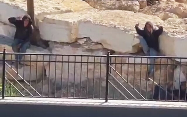 Settlers gesture to the camera as they remain outside the besieged homes of Palestinian residents in Qusra, near Nablus in the northern West Bank, August 13, 2026 (Video screenshot; used in accordance with Clause 27a of the Copyright Law)