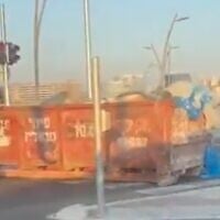 Dumpsters are placed on a road at the entrance to a neighborhood that has a significant secular population, in the ultra-Orthodox city of Bnei Brak, ahead of Shabbat on August 29, 2026. (Screenshot: X/Tuvya Yagelnik)