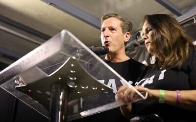 Ruby (left) and Hagit Chen, parents of Itay, an IDF soldier who was killed fighting Hamas-led terrorists on October 7, 2023, and his body abducted to Gaza and returned in November 2025, speak at a rally in Tel Aviv's Habima Square, August 8, 2026. (Yoav Loeff / Pro-Democracy Protest Movement)