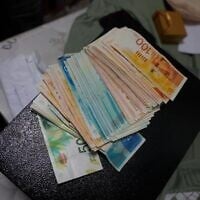 Cash seized by Israeli forces during a a raid on East Jerusalem homes of Palestinian prisoners who were released in exchange for Hamas-held hostages, and who allegedly continued receiving so-called 'pay-to-slay' stipends from the Palestinian Authority, in a photo released August 26, 2026. (Israel Police)