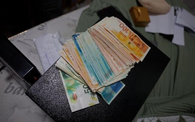Cash seized by Israeli forces during a a raid on East Jerusalem homes of Palestinian prisoners who were released in exchange for Hamas-held hostages, and who allegedly continued receiving so-called 'pay-to-slay' stipends from the Palestinian Authority, in a photo released August 26, 2026. (Israel Police)