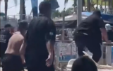 Security guards jump over a fence amid a brawl at the Yamit 2000 water park in Holon, on August 15, 2026. (Screenshot via Daniel Amram on X)