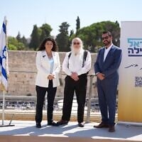 Sharren Haskel, left, Jonathan Pollard, center and political strategist Roi Danino in front of the Western Wall in Jerusalem, in a picture distributed on August 23, 2026. (Courtesy Israel First)