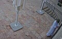 CCTV footage shows a masked individual gluing lock of Basimta cafe in Jerusalem, August 15, 2026. (Screen grab/Channel 12 via X)