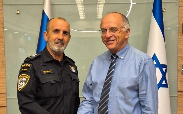 Police chief Daniel Levy, left, and Deputy Supreme Court President Noam Sohlberg, the chair of the Central Election Committee, pose during a meeting on August 13, 2026. (Israel Police)