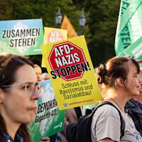 A banner reading 'Stop AfD Nazis' is seen during a demonstration against the rise of the far-right Alternative for Germany (AfD) party in front of the Brandenburg Gate in Berlin on September 7, 2026. (Emmanuele Contini/NurPhoto via Getty Images via JTA)