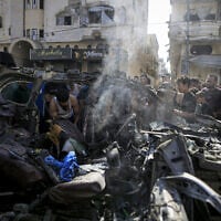 Palestinians gather to inspect the wreckage and damage at the site of an Israeli attack on a vehicle in the Tel al-Hawa neighborhood of Gaza City, on September 13, 2026 (Saeed M. M. T. Jaras / Anadolu via Reuters)