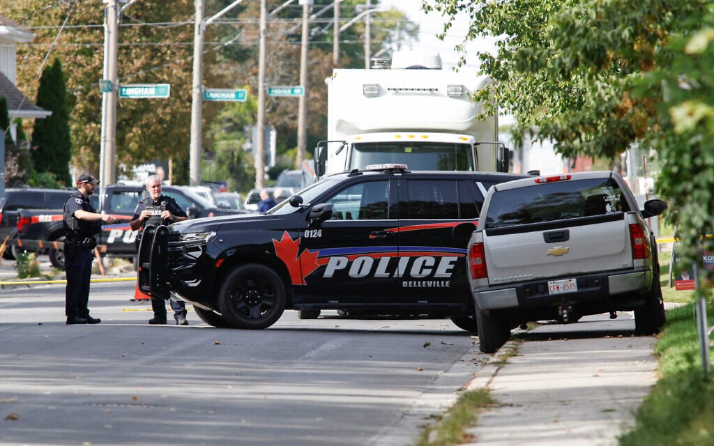 Police officers talk near the scene of a shooting where a police officer was shot outside a Yom Kippur gathering at Sons of Jacob Synagogue in Belleville, Ontario, Canada, September 21, 2026. (Patrick Doyle/Reuters) Police officers talk near the scene of a shooting where a police officer was shot outside a Yom Kippur gathering at Sons of Jacob Synagogue in Belleville, Ontario, Canada, September 21, 2026. (Patrick Doyle/Reuters)