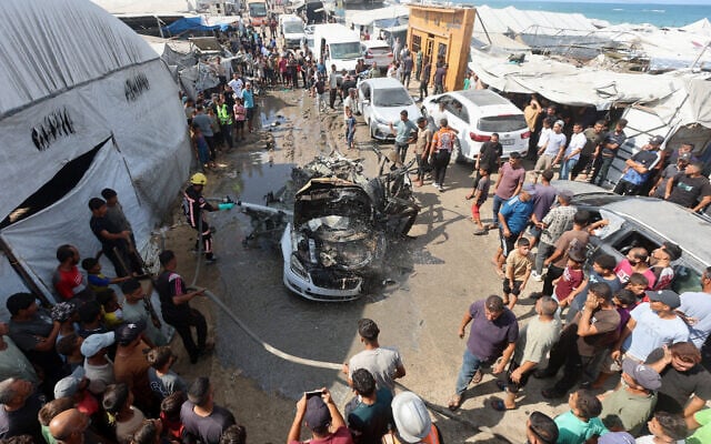 Palestinian firefighters extinguish a fire on a vehicle hit by an Israeli airstrike in Khan Younis, in the southern Gaza Strip, September 23, 2026. (Ramadan Abed/Reuters)