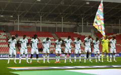 Ireland's soccer players bow their heads as the Israeli national anthem plays before their UEFA Nations League match in Debrecen, Hungary, September 27, 2026. (Bernadett Szabo/Reuters)