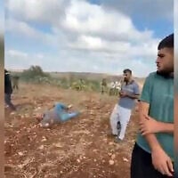 A man lies on the ground after he was shot in the leg by an IDF soldier on the outskirts of the Palestinian village of Faqoua, near Jenin, September 12, 2026 (Screen grab/used in accordance with Clause 27a of the Copyright Law)