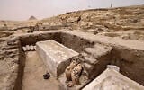 Visitors tour the site in the Saqqara necropolis south of Cairo, where archaeologists unearthed two human and animal embalming workshops, as well as two tombs, on May 27, 2023. (Khaled Desouki/AFP)