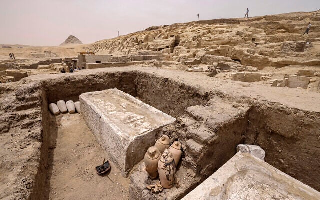 Visitors tour the site in the Saqqara necropolis south of Cairo, where archaeologists unearthed two human and animal embalming workshops, as well as two tombs, on May 27, 2023. (Khaled Desouki/AFP)