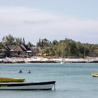 Beachgoers and tourists enjoy the sea near a private resort in Trou d’Eau Douce, Mauritius on January 7, 2024. (Gianluigi Guercia/AFP)